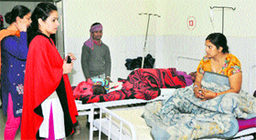 Jalandhar DC Shruti Singh (in red shawl) listens to a patients problems in Civil Hospital, Jalandhar, on Thursday. 