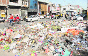 Heaps of garbage outside a dumping site near Plaza Chowk in Jalandhar on Thursday. No lifting of garbage took place today owing to slush on approach roads leading to the treatment plant at Wariana village near Jalandhar. 