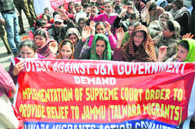 Members of the Talwara Migrants Action Committee stage a protest demanding implementation of Supreme Courts order regarding provision of relief to Talwara migrants, in Jammu on Thursday. 