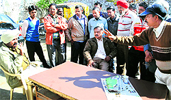 Members of the Labour Union argue with a police official at the PAU police station in Ludhiana