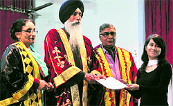 Santa Singh Umedhpur (second from left), chairman, Senior Secondary Board, Punjab, gives a certificate to a student during the annual prize distribution function at the Government College for Girls in Ludhiana on Thursday