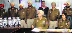 Inspector-General Gurpreet Deo displays the seized revolvers in Fatehgarh Sahib on Thursday. Tribune photo