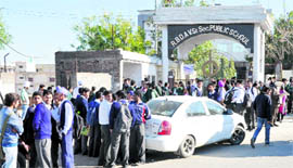 Students await entry to one of the examination centres in Bathinda on Friday.