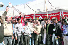 Government school teachers protest in front of the state Assembly in support of their demands in Dehradun on Friday.