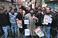 JKLF activists raise slogans while holding photographs of JKLF founder Maqbool Butt and Afzal Guru during a protest in Srinagar on Friday.