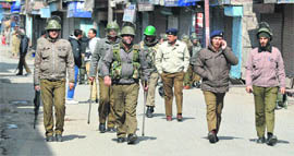 Security personnel patrol a deserted road in Maisuma, Srinagar, on Friday. 
