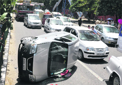 A car that turned turtle after hit by a speeding vehicle near the Government Women College, Gandhi Nagar, in Jammu. Tribune photo: Anand Sharma
