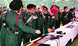 Army personnel and their wives take a look at an exhibition on the 64th Raising Day of the Vajra Corps in Jalandhar Cantonment on Friday