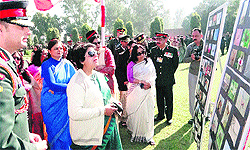 Army personnel and their wives take a look at an exhibition on the 64th Raising Day of the Vajra Corps in Jalandhar Cantonment on Friday