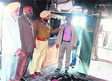 Police officials inspect the gutted house at Galib Kalan village near Jagraon on Friday. 