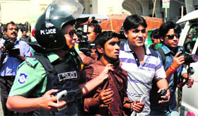 The police detains a suspected Jamaat-e-Islami activist in Dhaka on Friday.