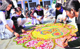Students of SMJN PG College take part in a rangoli competition in Haridwar on Saturday.