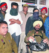 Policemen with two school-going boys, belonging to high-profile families of the city, after they were arrested for snatching the purse of a woman near Ravidas Chowk in Jalandhar on Friday night.