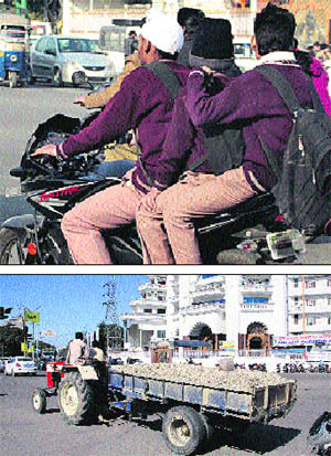 Above) Underage driving continues as minors drive a bike openly in Jalandhar; despite a ban, a tractor-trailer (below) being openly used for commercial purposes in the Model Town area of the city on Saturday.