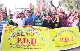 Members of the All Jammu and Kashmir Casual Labourers Union of the Power Development Department hold a protest in Jammu on Saturday