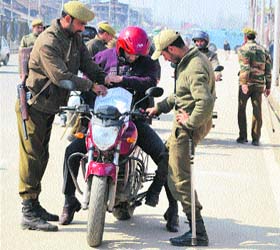 On guard: Following killing of two policemen in Handwara, security personnel conduct checks in Srinagar on Saturday