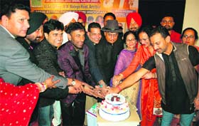 Members of the Idiot Club and Punjabi artists cut a cake to celebrate the birth anniversary of Jaspal Bhatti at the Art Gallery in Amritsar on Sunday