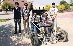 Engineering students, headed by Kashish Malik with the car prepared by them, at Pushpa Gujral Science City (PGSC) on National Science Day in Kapurthala