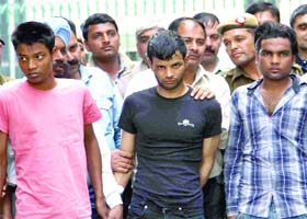 Delhi Police showing the three accused after their arrest in connection with the murder of two siblings, at PHQ in New Delhi on Sunday