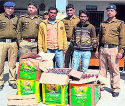 Police personnel with the two accused at the Jwalapur police station in Haridwar on Sunday