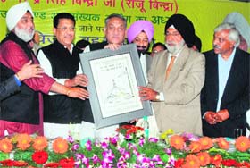 Chief Minister Vijay Bahuguna being felicitated by newly appointed Chairman of the Uttarakhand Minorities Commission Narender Singh Bindra at a function in Dehradun on Sunday
