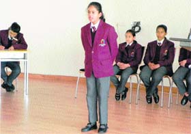 A student participates in an English poem recitation competition at Ecole Globale International Girls School in Dehradun
