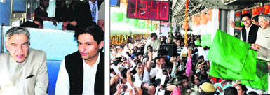 Union Railway Minister Pawan Bansal and Deepender Singh Hooda, MP, travel in the Rohtak-Delhi mainline electric multiple unit train after it was flagged off by the minister (right) at Rohtak on Sunday. 