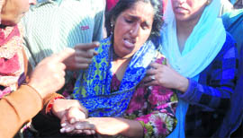 A woman shows her injuries at Muradpur in Rajouri on Sunday.