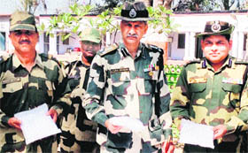 BSF men show the seized heroin at the Daoke outpost on Monday.
