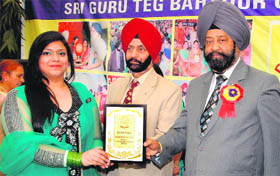 GNDU Registrar Dr Inderjit Singh gives away degree to a student during the prize distribution function of Sri Guru Teg Bahadur College in Amritsar on Monday.