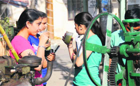 Girls relish sugarcane juice at a vend on the Mall Road in Bathinda on Monday.