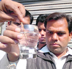 A resident shows the earthworm received in the supply water in Paras Ram Nagar area on Monday.