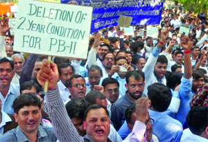 Members of the Federation of Indian Pharmacist Organisation shout slogans during a demonstration for their various demands at Jantar Mantar in New Delhi on Monday.