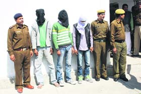 The men accused of committing a Rs 12 lakh heist in police custody at Rohtak on Monday