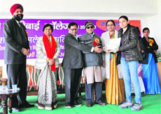 State poet Udai Bhanu Hans (centre) and Haryana Granth Akademi deputy chairman Kamlesh Bhartiya give away prizes to winners of a poetry-recitation competition at Maharani Luxmi Bai College for Women, Bhiwani Rohilla, in Hisar. 