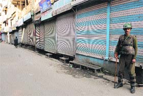 A security personnel keeps vigil in Srinagar on Monday