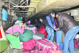 Stranded passengers board an IAF aircraft in Jammu on Monday