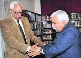 Minister for Planning and Development Ajay Sadhotra greets Governor NN Vohra