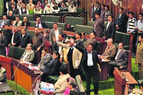 Legislators expelled from the BJP walk out from the Assembly in Jammu on Monday
