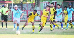 Players in action during the Rajiv Gandhi Gold Cup Football Tournament at GGM Science College in Jammu on Monday. Tribune photo: Inderjeet Singh
