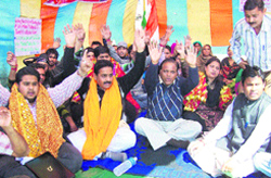 Members of the Bahu Fort Development Committee sit in dharna in Bahu area of Jammu on Monday. Tribune photo