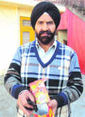 Ravinder Singh showing the rotten fruit found in the juice packet. 