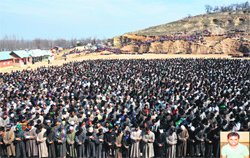 Villagers pray by the body of Muddasir Ahmed Malla (inset) at Parigam village in Pulwama district on Monday. Tribune photo: Amin War