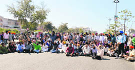 Riot victims squat on Ferozepur Road opposite GLADA office in Ludhiana on Monday. 