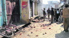 Policemen guard a street after curfew was clamped in the Tanda area of Uttar Pradesh on Monday.
