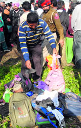 People look for schoolbags of their children at the accident site at Jaheera village near Nakodar