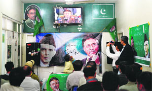 Activists of the All-Pakistan Muslim League watch the press conference of their leader former President Pervez Musharraf in Karachi.