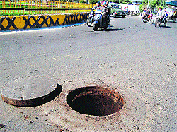 A manhole lying open in the middle of a road near Circuit House in Amritsar