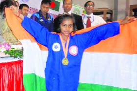 Ishika Goel carries the National Flag after winning the Asian Martial Arts Championship in Dhaka