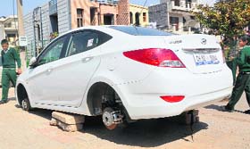 Grounded: A boy looks at a car, the wheels of which were stolen by thieves in Sector 69, Mohali, on Tuesday